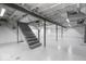 A large unfinished basement with concrete walls and floors provides opportunity for future living space at 4809 Allisonville Rd, Indianapolis, IN 46205