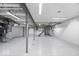 A large unfinished basement with concrete walls and floors provides opportunity for future living space at 4809 Allisonville Rd, Indianapolis, IN 46205