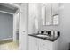Modern bathroom with elegant fixtures, marble counters and updated cabinets at 4809 Allisonville Rd, Indianapolis, IN 46205