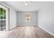 Bright and airy bedroom features laminate floors, ceiling fan, and natural light at 4809 Allisonville Rd, Indianapolis, IN 46205