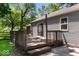 Exterior shot of wooden deck, with wooden railings, siding, sliding glass doors, and natural light at 4809 Allisonville Rd, Indianapolis, IN 46205