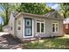 Charming single-story home with light gray siding, a neatly manicured lawn, and a secure screen door at 4809 Allisonville Rd, Indianapolis, IN 46205