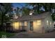 The exterior view showcases the side of the home with wood siding, windows, and a porch at 4809 Allisonville Rd, Indianapolis, IN 46205
