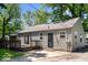 A view of the side of the house with a small wooden deck, siding, and a security door at 4809 Allisonville Rd, Indianapolis, IN 46205