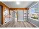 Open-concept living room with hardwood floors, built-in shelves, and large windows at 4809 Allisonville Rd, Indianapolis, IN 46205