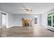 Modern living room with a fireplace, light hardwood floors, and multiple windows at 4809 Allisonville Rd, Indianapolis, IN 46205