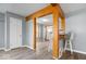 Stylish living room with hardwood floors, wood beams, and a breakfast bar area leading to the kitchen at 4809 Allisonville Rd, Indianapolis, IN 46205