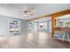 Bright and airy living room with hardwood floors, ceiling fan, and large windows at 4809 Allisonville Rd, Indianapolis, IN 46205