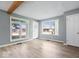 Spacious living room with wood beam accents, hardwood floors, and large windows for ample sunlight at 4809 Allisonville Rd, Indianapolis, IN 46205