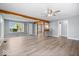 Open-concept living area with hardwood floors, exposed wood beams, and plenty of natural light at 4809 Allisonville Rd, Indianapolis, IN 46205