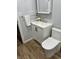 Bathroom with modern vanity, faucet, and toilet and wood-look flooring at 5725 W 200 N, Lebanon, IN 46052