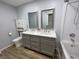 Bathroom featuring double sinks with framed mirrors, granite countertops, and tub at 5725 W 200 N, Lebanon, IN 46052
