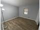 Bright bedroom features wood-look flooring and a window letting in natural light at 5725 W 200 N, Lebanon, IN 46052
