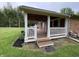 Covered back patio featuring wood ceiling, white columns and railing, ideal for entertaining or relaxation at 5725 W 200 N, Lebanon, IN 46052