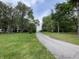 Long gravel driveway framed by trees and green lawn leads to the home at 5725 W 200 N, Lebanon, IN 46052