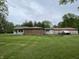 Exterior view of the home highlighting the large yard and covered porch and detached garage at 5725 W 200 N, Lebanon, IN 46052