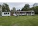 Charming brick home featuring a spacious front yard and white railed porch, perfect for relaxing outdoors at 5725 W 200 N, Lebanon, IN 46052