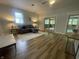 Living room with wood-look flooring and a sliding door to a sunroom at 5725 W 200 N, Lebanon, IN 46052