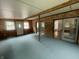 Spacious living space featuring carpet, wood paneled walls and access to other rooms at 5725 W 200 N, Lebanon, IN 46052