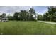 Expansive green lawn features mature trees and a playground set at 5725 W 200 N, Lebanon, IN 46052