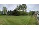 Spacious green yard with mature trees and landscaping surrounding the home at 5725 W 200 N, Lebanon, IN 46052