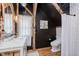 Bathroom with exposed beams, marble countertop, and white shower curtain offers a rustic, yet modern, elegant space at 584 S 10Th St, Noblesville, IN 46060