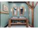 Farmhouse style bathroom with wood vanity, dual sinks, and exposed wood support beams at 584 S 10Th St, Noblesville, IN 46060