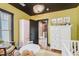 This Bedroom has hardwood floors, yellow walls, and white furnishings at 584 S 10Th St, Noblesville, IN 46060