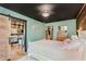 Cozy bedroom with an adjoining bathroom showing a modern aesthetic, a sliding door, and an abundance of light at 584 S 10Th St, Noblesville, IN 46060