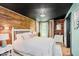 Bright bedroom features a wooden accent wall, white furniture, and natural light creating a peaceful and stylish retreat at 584 S 10Th St, Noblesville, IN 46060