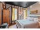 Cozy bedroom features exposed beams, yellow curtains, and a comfortable bed at 584 S 10Th St, Noblesville, IN 46060