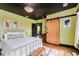 This bedroom has hardwood floors, a black ceiling and a sliding wooden barn door at 584 S 10Th St, Noblesville, IN 46060
