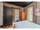 Charming bedroom featuring exposed brick, wood beams, and stylish black sliding door, offering a unique rustic aesthetic at 584 S 10Th St, Noblesville, IN 46060