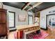 Elegant dining room with a long table, benches, and stylish decor and hardwood floors at 584 S 10Th St, Noblesville, IN 46060