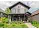 Charming two-story home featuring a covered front porch and beautifully landscaped yard at 584 S 10Th St, Noblesville, IN 46060