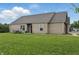 The backyard features a lush green lawn and a seating area, perfect for outdoor relaxation and entertaining at 608 Fisher Creek Dr, Indianapolis, IN 46239