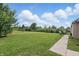 Expansive backyard with lush greenery, a patio set, and scenic views at 608 Fisher Creek Dr, Indianapolis, IN 46239