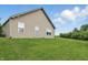 A view of the backyard under a sunny sky shows the grassy area at 608 Fisher Creek Dr, Indianapolis, IN 46239