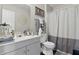 Well-lit bathroom featuring neutral decor, a vanity with storage, and a shower with a curtain at 608 Fisher Creek Dr, Indianapolis, IN 46239