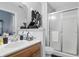 Bright bathroom featuring a wood vanity, framed mirror, and glass-enclosed shower at 608 Fisher Creek Dr, Indianapolis, IN 46239