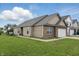 Charming single-Gathering home with a well-manicured lawn and an attached two-car garage at 608 Fisher Creek Dr, Indianapolis, IN 46239