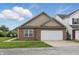 A brick and vinyl sided single Gathering home with an attached two-car garage, concrete driveway, and a front lawn at 608 Fisher Creek Dr, Indianapolis, IN 46239