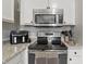 Modern kitchen with stainless steel appliances, stylish countertop, and hanging towel accents at 608 Fisher Creek Dr, Indianapolis, IN 46239