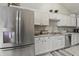 Bright kitchen featuring white cabinets, modern stainless steel appliances, and marble flooring at 608 Fisher Creek Dr, Indianapolis, IN 46239