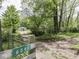 Gated driveway with the number 6091, leading to a home with a garage, set against a backdrop of lush greenery at 6091 Mt Moriah Rd, Nineveh, IN 46164