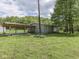 Exterior of a home with a covered carport, surrounded by a green lawn and mature trees at 6091 Mt Moriah Rd, Nineveh, IN 46164