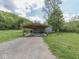 Scenic exterior view of a home with a covered parking area and lush greenery, offering a peaceful retreat at 6091 Mt Moriah Rd, Nineveh, IN 46164