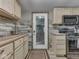 Functional kitchen featuring wood countertops, appliances, and rustic door at 6091 Mt Moriah Rd, Nineveh, IN 46164