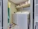 Bright laundry room featuring a washer, dryer, storage shelf, and modern flooring at 6091 Mt Moriah Rd, Nineveh, IN 46164