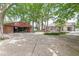 Backyard featuring a large paved area, storage shed, and landscaped yard at 6110 Orinoco Ave, Indianapolis, IN 46227